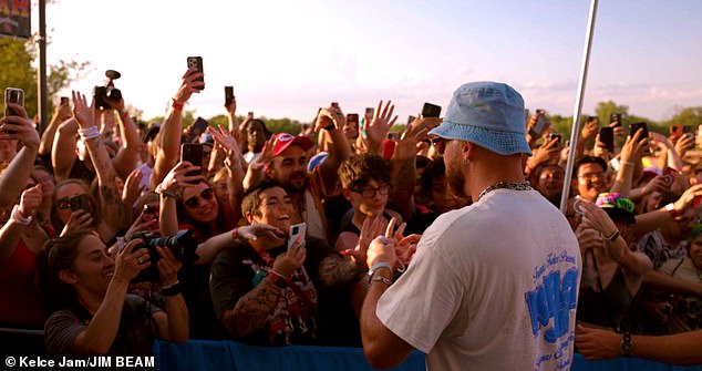 Kelce arrived at the festival in blue jeans and a bob hat as he greeted fans before the show