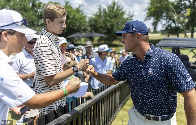 Брайсон ДеШамбо из Crushers GC приветствует болельщика во время первого раунда LIV Golf Nashville